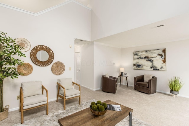 living room with a high ceiling, light colored carpet, and crown molding