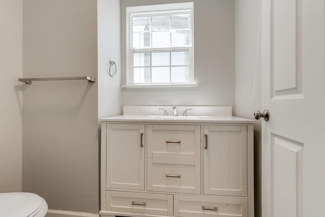 bathroom featuring vanity and toilet