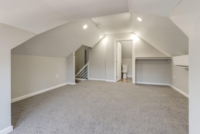 additional living space with carpet floors and vaulted ceiling