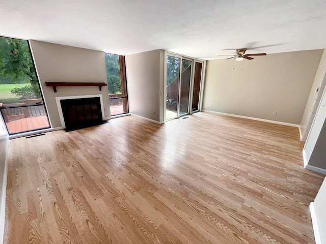 unfurnished living room with ceiling fan and light hardwood / wood-style floors