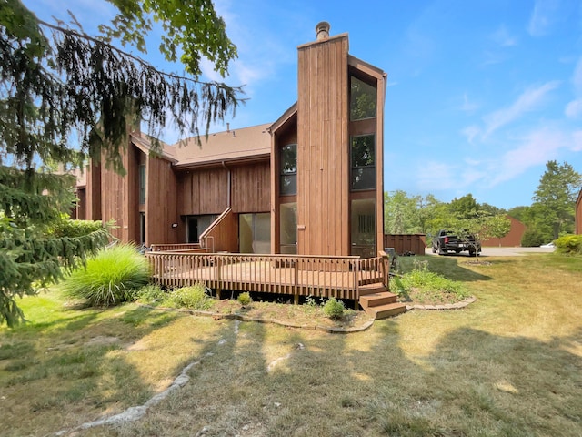 exterior space featuring a deck and a lawn