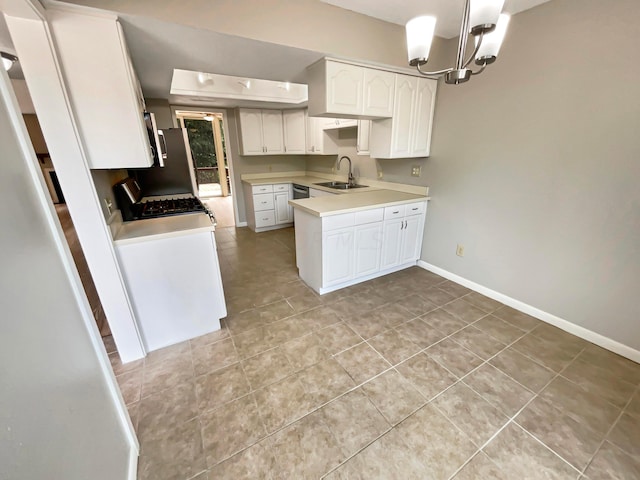 kitchen featuring sink, hanging light fixtures, light tile patterned floors, an inviting chandelier, and white cabinets