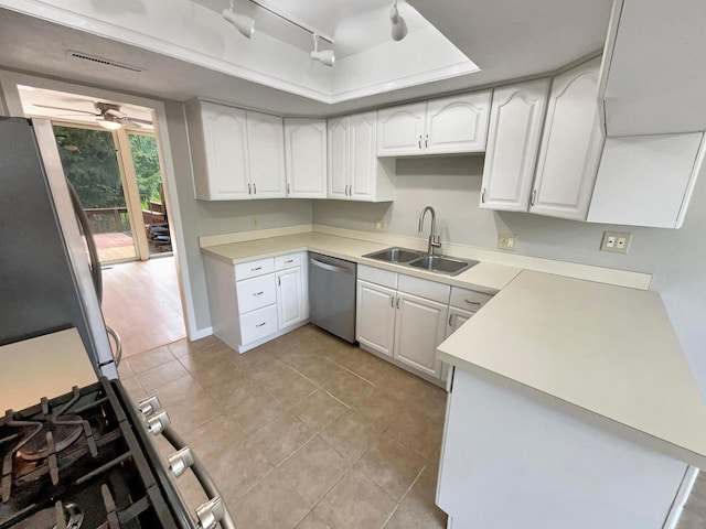 kitchen featuring sink, ceiling fan, appliances with stainless steel finishes, light tile patterned flooring, and white cabinetry