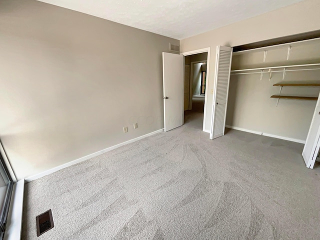 unfurnished bedroom featuring carpet floors and a closet