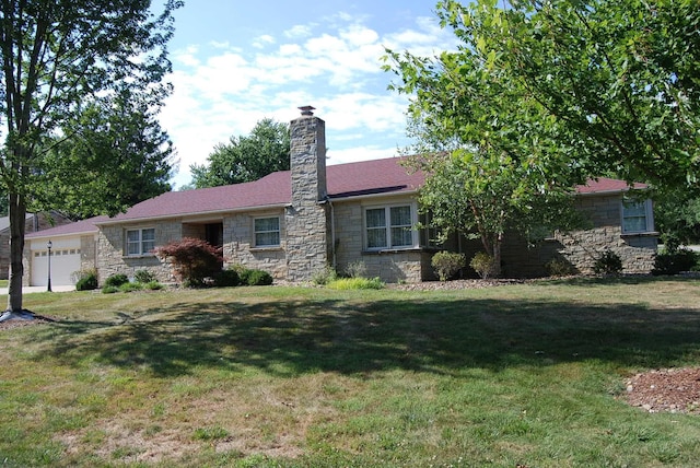 single story home with a front yard and a garage