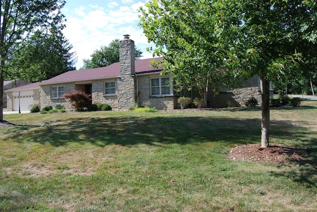 ranch-style house with a front yard and a garage