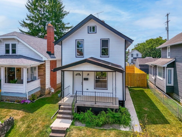 view of front of home with a front yard and a porch