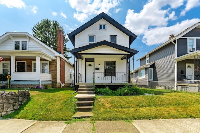 bungalow-style house featuring a porch and a front yard