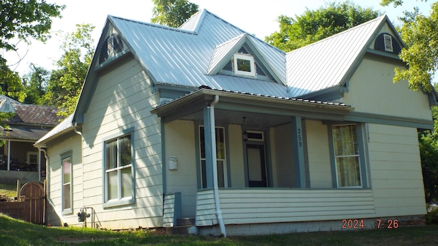 view of side of property featuring covered porch