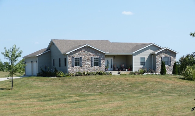 ranch-style home featuring a garage and a front lawn