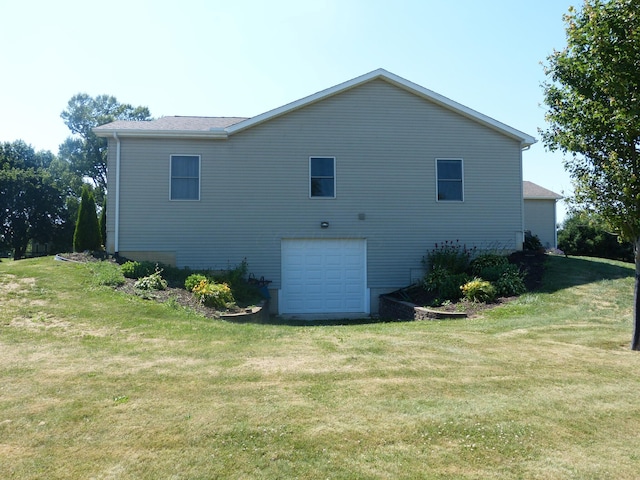 view of home's exterior featuring a garage and a yard