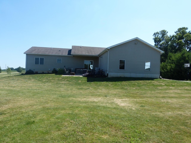 rear view of house with a lawn and a patio area