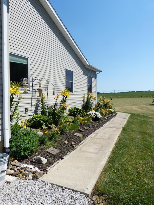 view of side of home with a yard