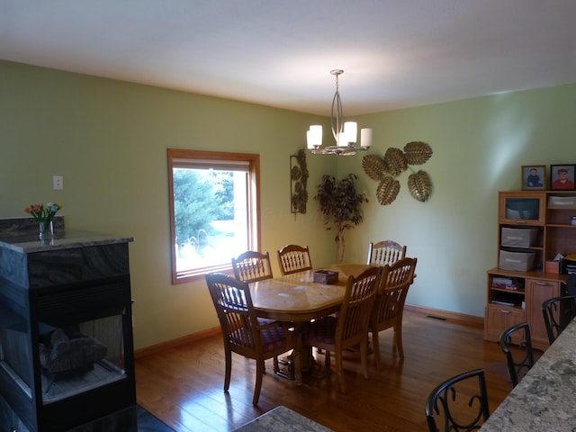 dining area featuring a chandelier and wood-type flooring