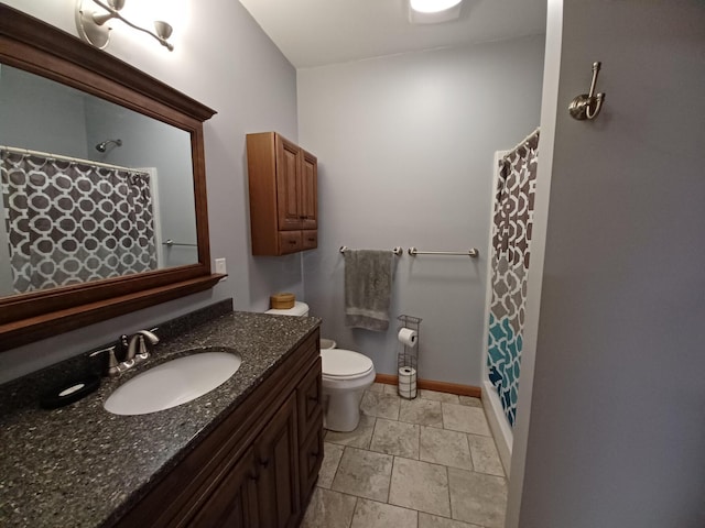 bathroom featuring vanity, toilet, and walk in shower