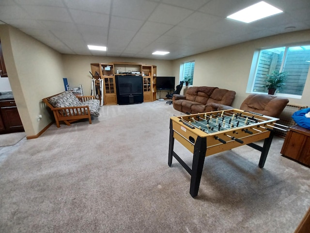 game room with carpet floors and a paneled ceiling