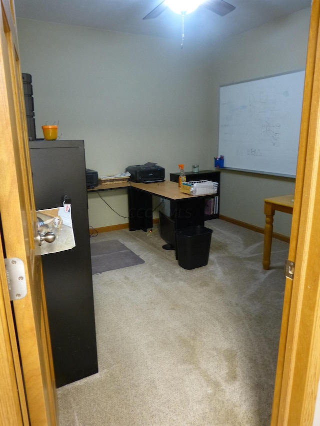 carpeted office space with ceiling fan