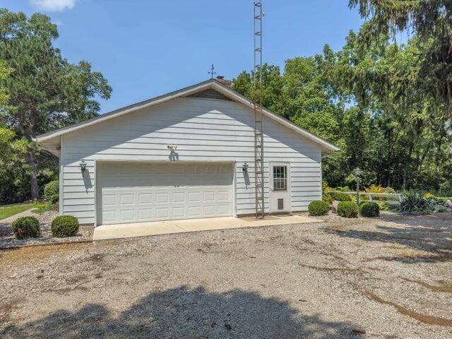 view of home's exterior with an outdoor structure and a garage