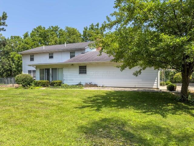 rear view of house with a lawn