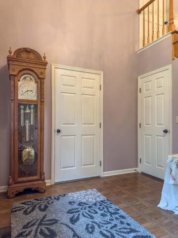 bedroom with dark parquet floors and a towering ceiling