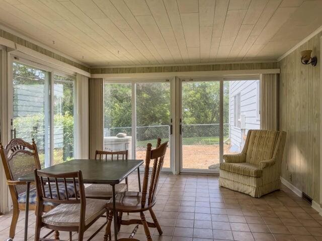 sunroom / solarium featuring wood ceiling and a wealth of natural light