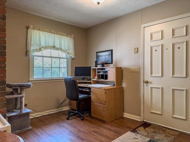 office space featuring dark wood-type flooring and a textured ceiling