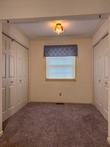 unfurnished bedroom with carpet floors and ornamental molding