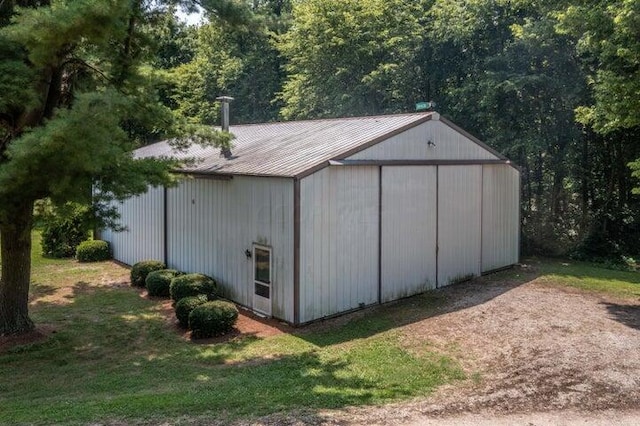 view of outdoor structure featuring a lawn