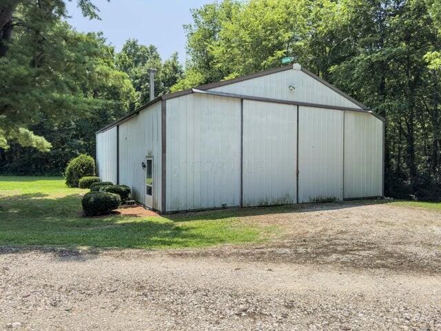 view of outbuilding featuring a lawn