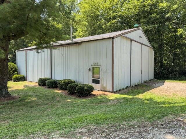 view of outbuilding with a lawn