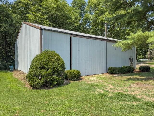 view of outbuilding with a yard