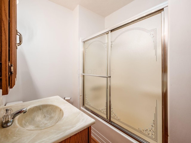 bathroom with vanity and enclosed tub / shower combo