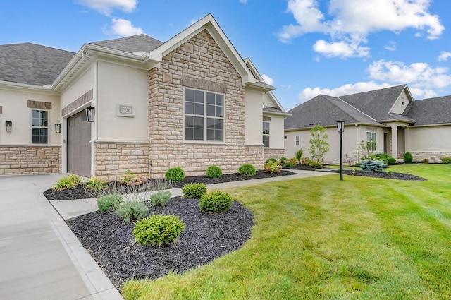 view of front of house with a garage and a front lawn