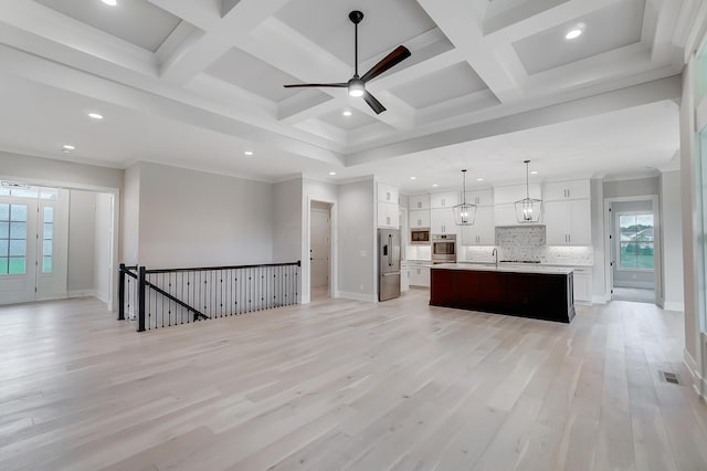 unfurnished living room with light wood-type flooring, coffered ceiling, ceiling fan, crown molding, and beamed ceiling