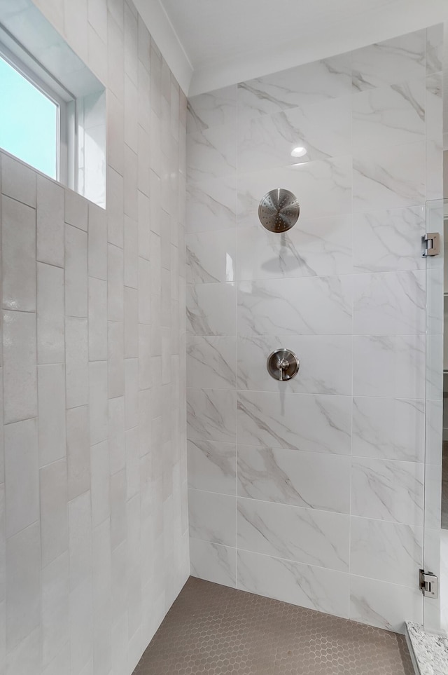 bathroom with tiled shower