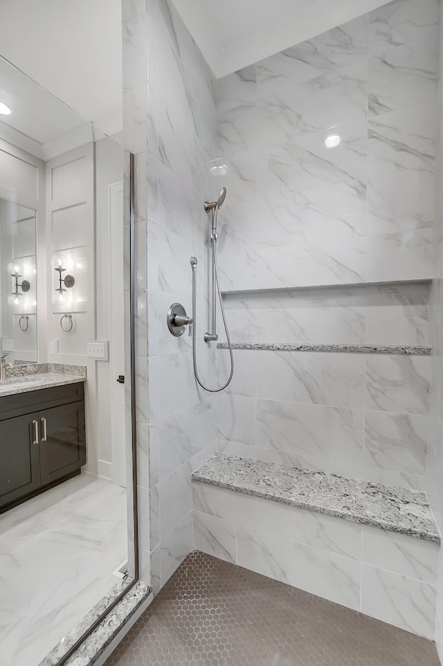 bathroom with vanity and tiled shower