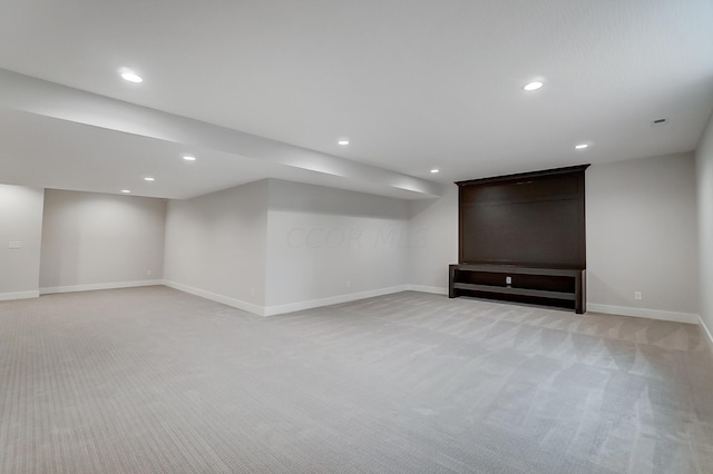 basement featuring light carpet