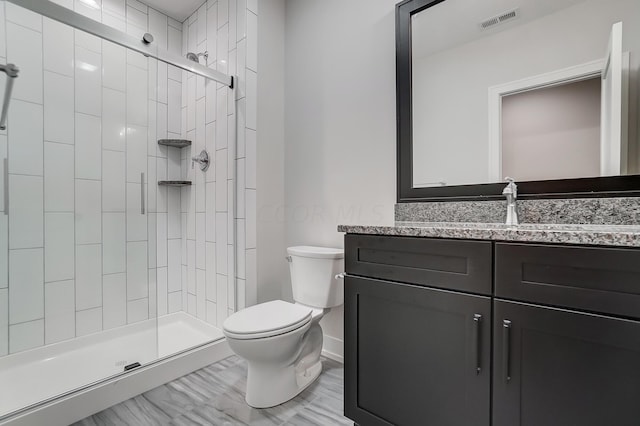 bathroom with vanity, toilet, and walk in shower