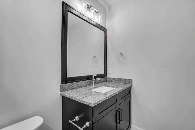 bathroom featuring vanity and toilet