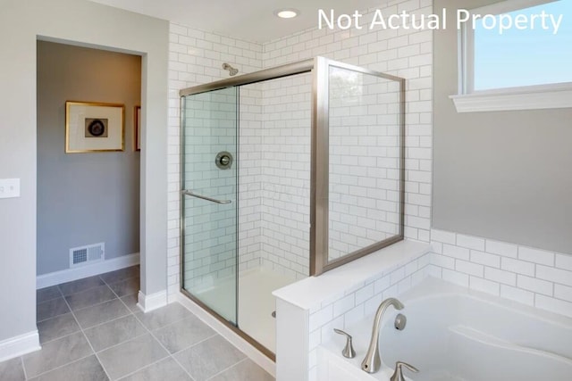 bathroom with shower with separate bathtub and tile patterned floors