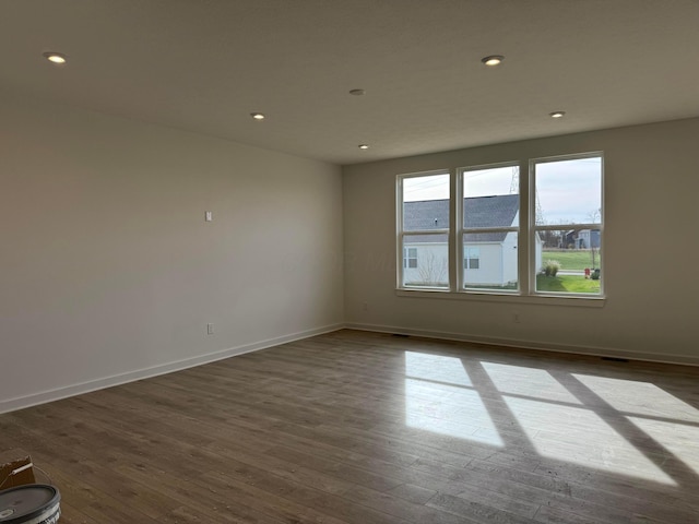 unfurnished room featuring dark hardwood / wood-style floors