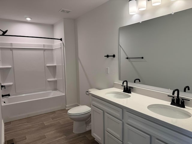 full bathroom with hardwood / wood-style flooring, vanity, toilet, and bathing tub / shower combination