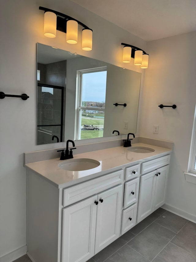 bathroom featuring tile patterned flooring, vanity, and an enclosed shower