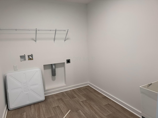 washroom with hookup for an electric dryer, hookup for a washing machine, and dark hardwood / wood-style flooring