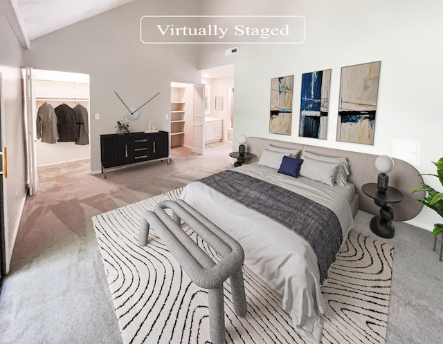 carpeted bedroom featuring vaulted ceiling and ensuite bath