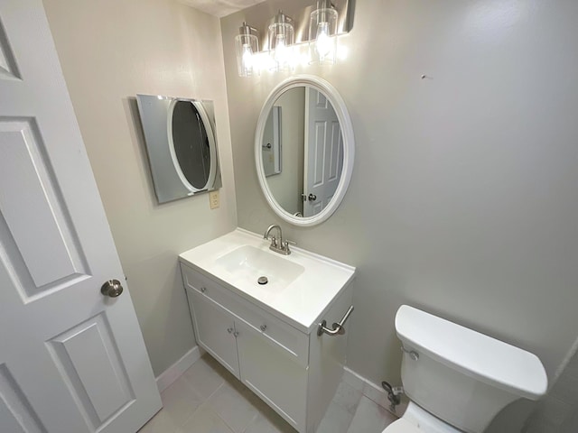 bathroom featuring tile patterned flooring, vanity, and toilet