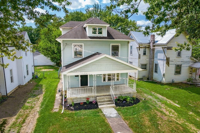 view of front of property featuring a front lawn and covered porch