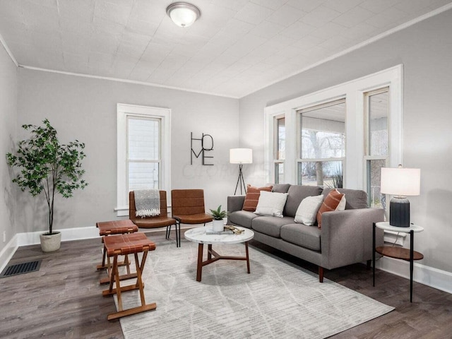 living room with hardwood / wood-style flooring and crown molding