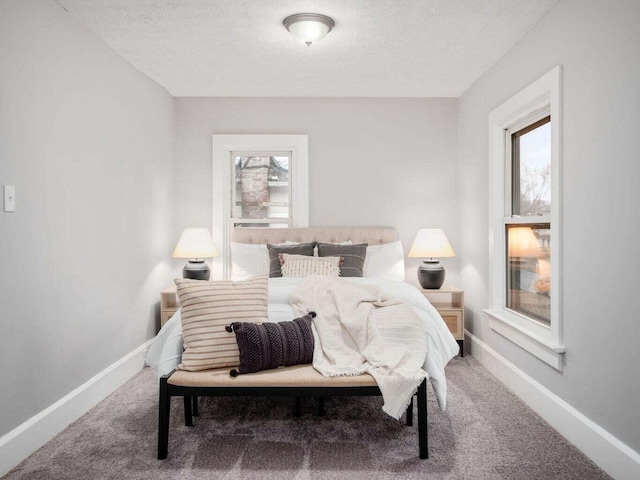 carpeted bedroom featuring a textured ceiling