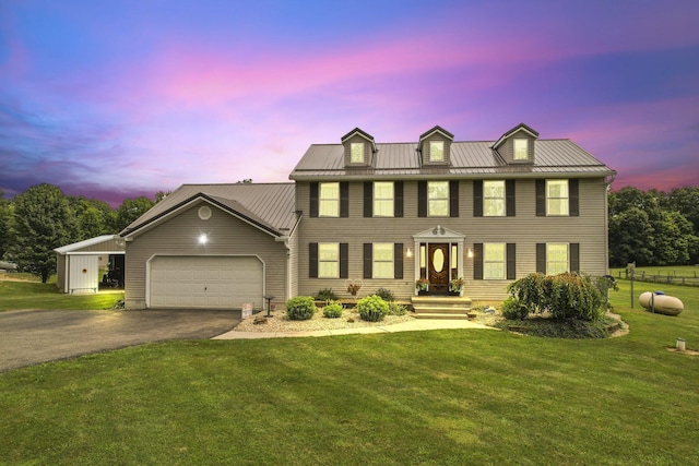 colonial house with a lawn and a garage